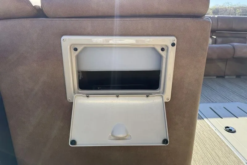 Slide: The Image of Open storage compartment on 2026 Premier 330 Escalante boat seat. - 26