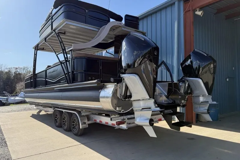Slide: The Image of 2026 Premier 330 Escalante pontoon boat with dual engines on a trailer. - 3