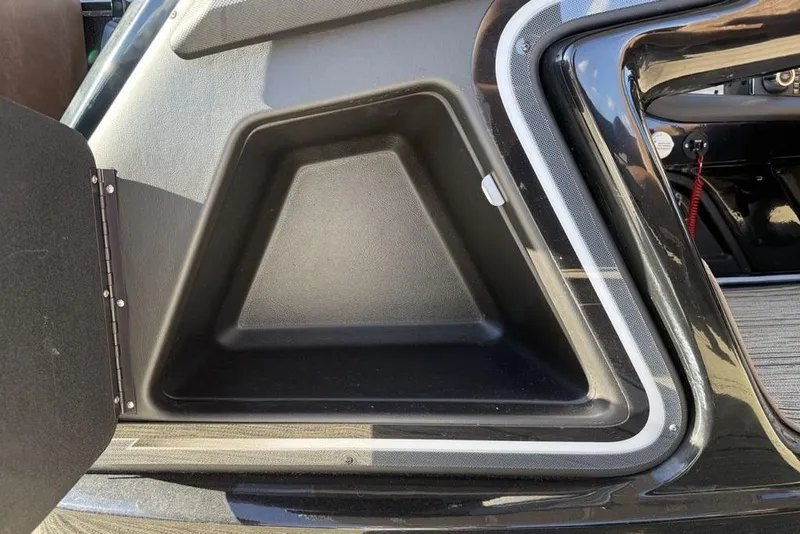 Slide: The Image of Storage compartment of 2026 Premier 330 Escalante boat, featuring sleek black interior design. - 30