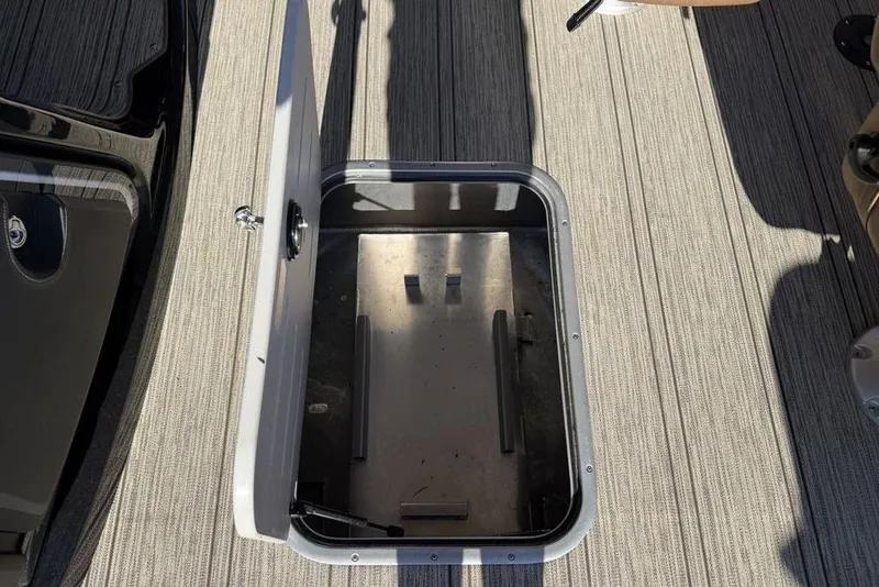 Slide: The Image of Open storage compartment on 2026 Premier 330 Escalante boat deck. - 33