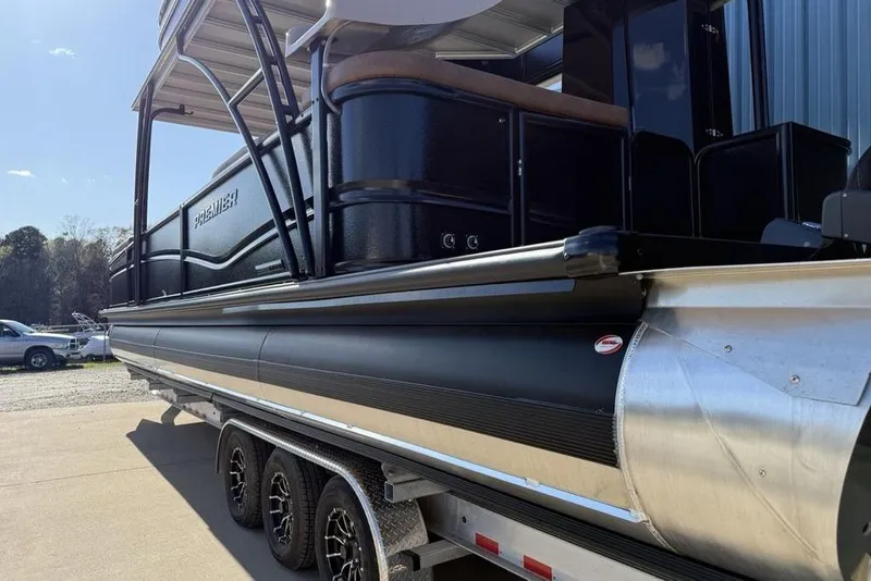 Slide: The Image of 2026 Premier 330 Escalante pontoon boat on trailer, side view in outdoor setting. - 4