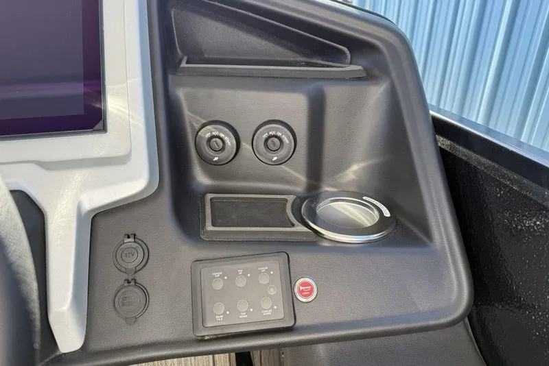 Slide: The Image of Control panel of 2026 Premier 330 Escalante boat with switches and cup holder. - 42