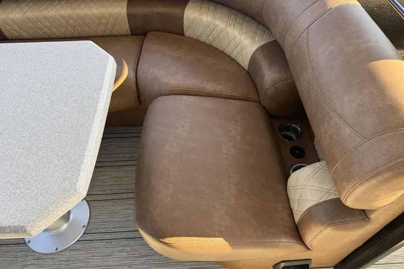 Slide: The Image of Luxurious seating area in 2026 Premier 330 Escalante boat with table and cup holders. - 43