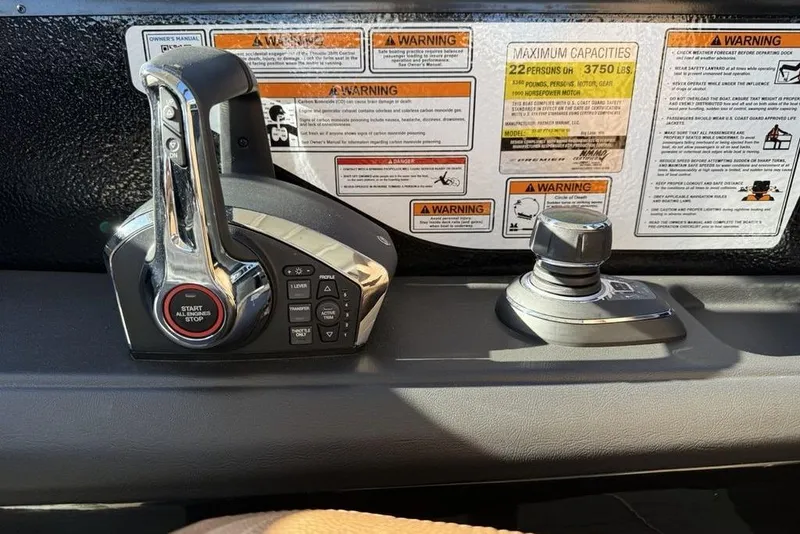 Slide: The Image of Control panel of 2026 Premier 330 Escalante with warning labels and start-stop button. - 44