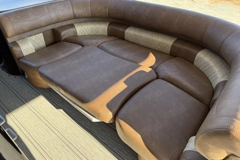 Slide: The Image of Luxurious seating in 2026 Premier 330 Escalante boat, featuring brown and beige upholstery. - 53