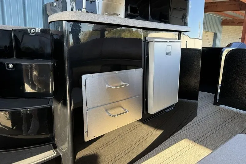 Slide: The Image of 2026 Premier 330 Escalante boat interior with sleek cabinetry and stainless steel accents. - 55