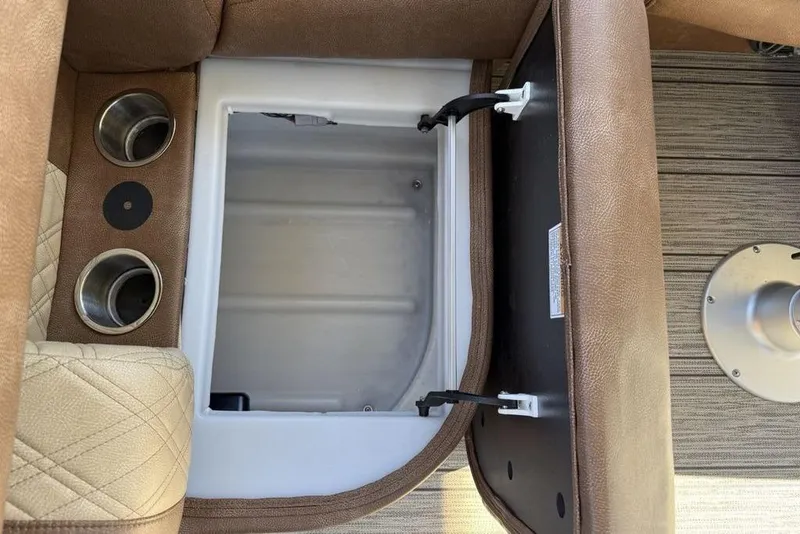 Slide: The Image of Open storage compartment in 2026 Premier 330 Escalante boat with cup holders. - 56