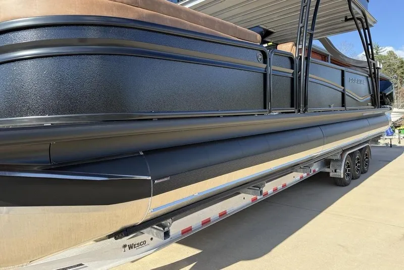 Slide: The Image of 2026 Premier 330 Escalante pontoon boat on a trailer, side view. - 6