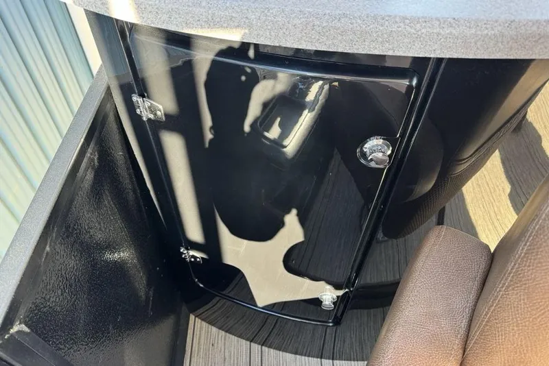 Slide: The Image of 2026 Premier 330 Escalante interior detail with black cabinet and brown seating. - 70