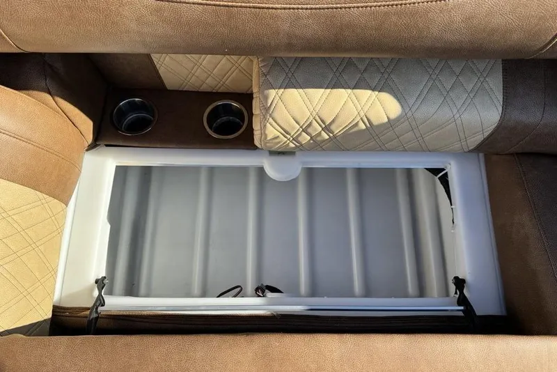 Slide: The Image of Interior of 2026 Premier 330 Escalante with storage compartment and cup holders. - 77