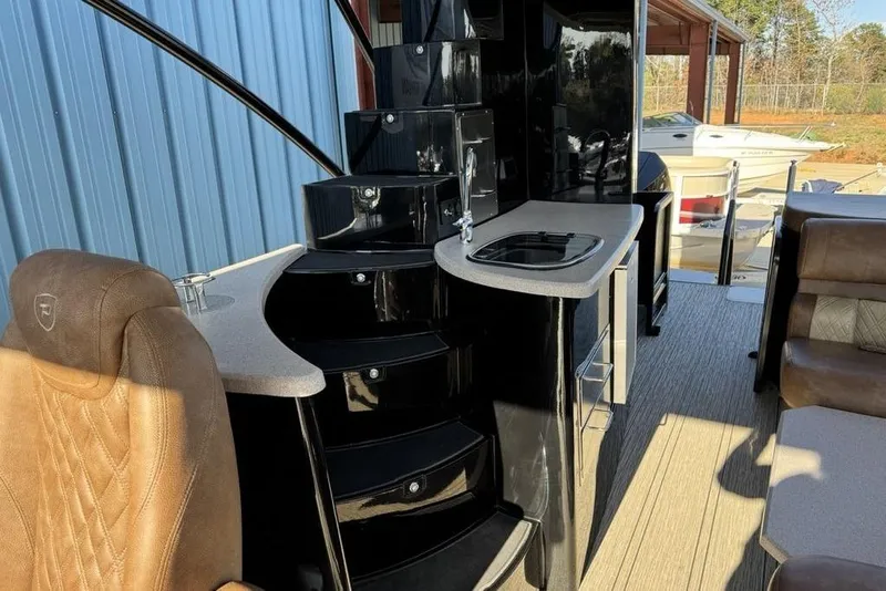 Slide: The Image of Luxurious interior of 2026 Premier 330 Escalante boat with sleek black staircase and seating. - 78