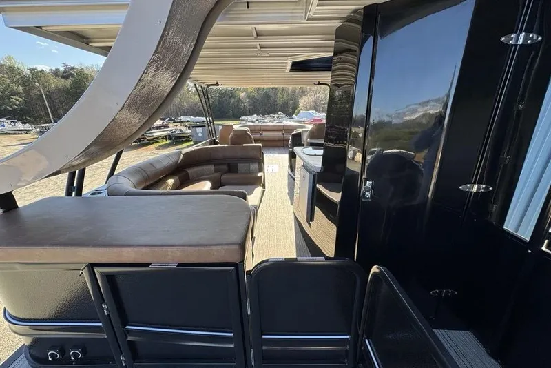 Slide: The Image of Luxurious interior of 2026 Premier 330 Escalante pontoon boat with seating and amenities. - 91