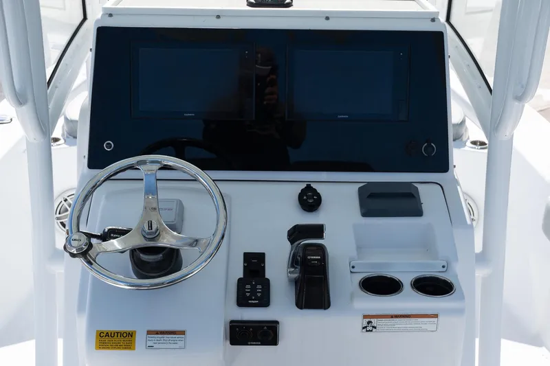 Slide: The Image of 2020 Sportsman Masters 267 Bay Boat dashboard with steering wheel and controls. - 10