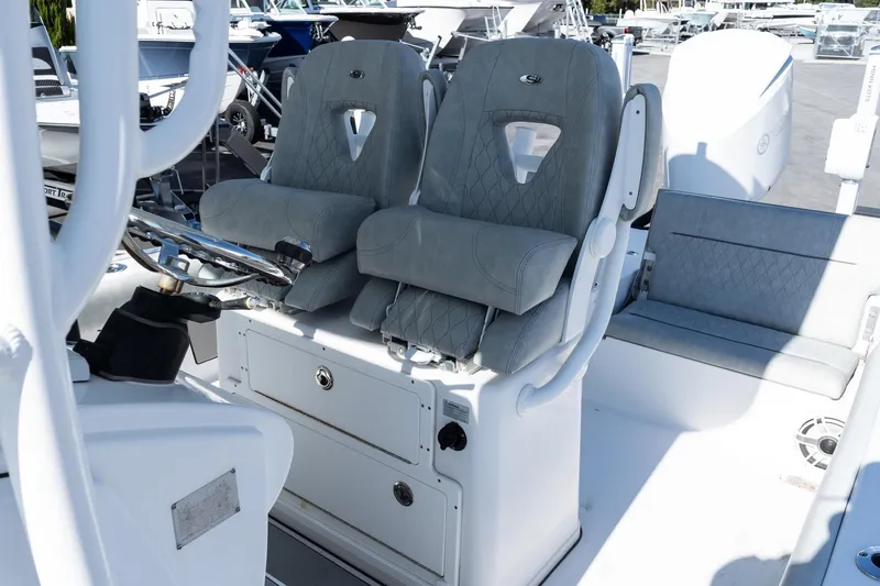 Slide: The Image of 2020 Sportsman Masters 267 Bay Boat interior with dual helm seats and steering wheel. - 11