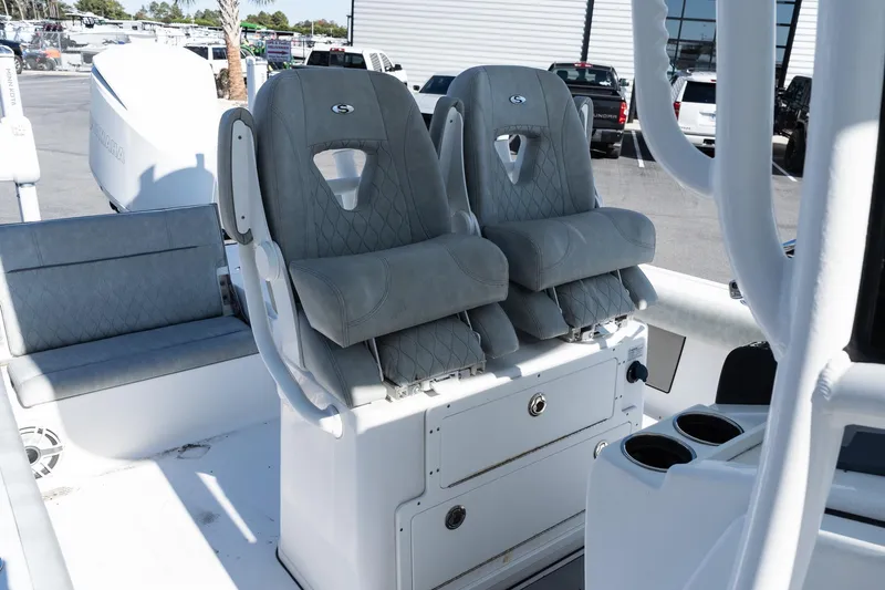 Slide: The Image of 2020 Sportsman Masters 267 Bay Boat interior with dual cushioned seats and storage. - 12