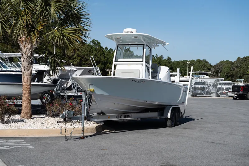 Slide: The Image of 2020 Sportsman Masters 267 Bay Boat on trailer, parked near palm tree. - 3