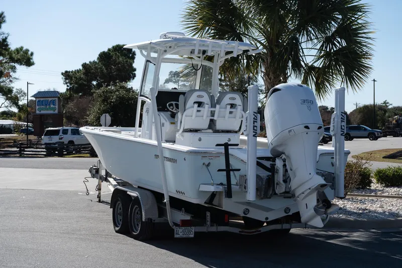 Slide: The Image of 2020 Sportsman Masters 267 Bay Boat on trailer, parked outdoors near palm trees. - 4