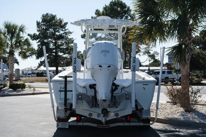 Slide: The Image of 2020 Sportsman Masters 267 Bay Boat with powerful outboard motor, parked near palm trees. - 5