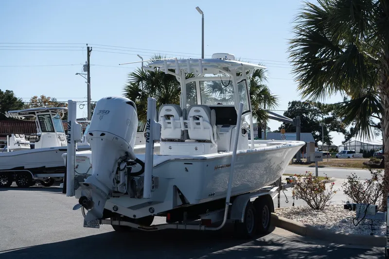 Slide: The Image of 2020 Sportsman Masters 267 Bay Boat on trailer, parked outdoors near palm trees. - 6