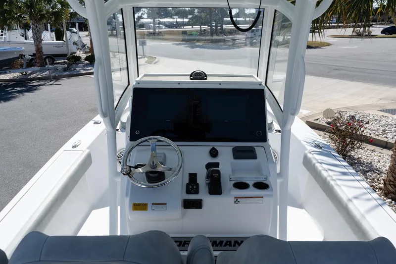 Slide: The Image of 2020 Sportsman Masters 267 Bay Boat cockpit with steering wheel and control panel. - 9