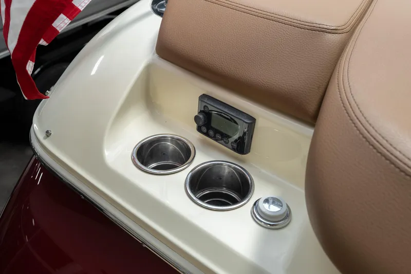 Slide: The Image of 2026 Chris-Craft Sportster 28 boat interior with cup holders and control panel. - 15