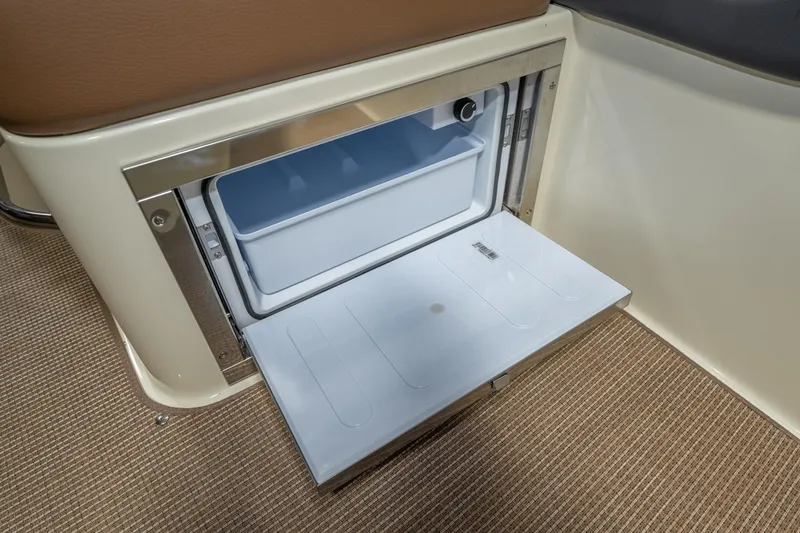 Slide: The Image of 2026 Chris-Craft Sportster 28 interior with open storage compartment on carpeted floor. - 18
