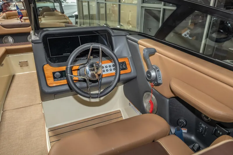 Slide: The Image of 2026 Chris-Craft Sportster 28 boat interior with steering wheel and control panel. - 19