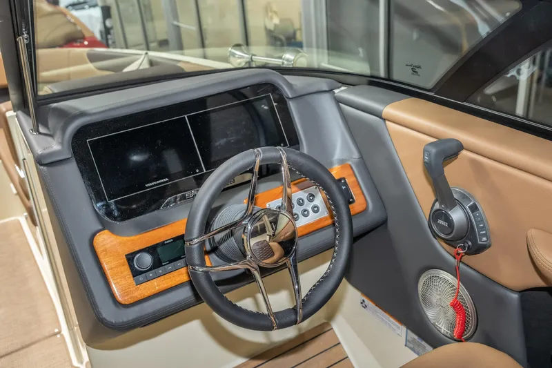 Slide: The Image of 2026 Chris-Craft Sportster 28 dashboard with steering wheel and control panel. - 21