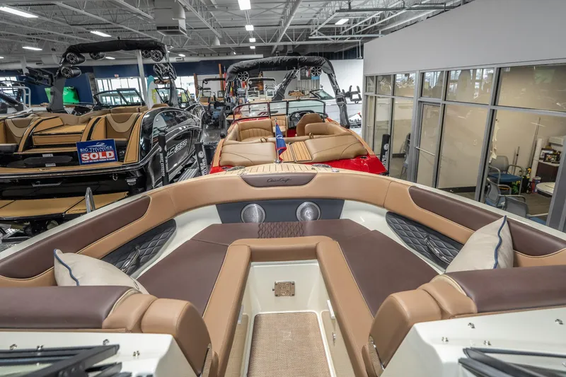 Slide: The Image of 2026 Chris-Craft Sportster 28 luxury boat interior in showroom, featuring elegant seating and modern design. - 22