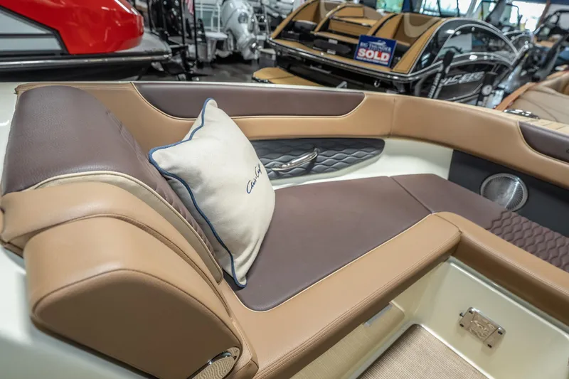 Slide: The Image of Luxurious interior of 2026 Chris-Craft Sportster 28 with elegant seating and branded cushion. - 23