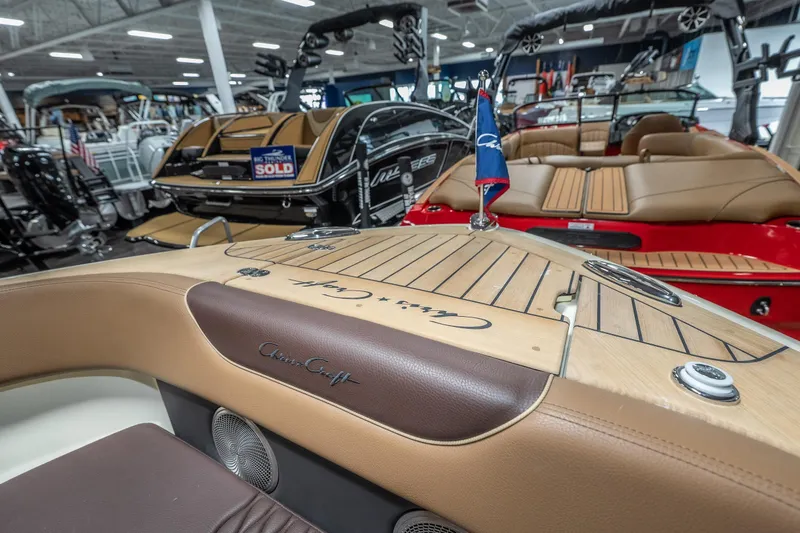 Slide: The Image of 2026 Chris-Craft Sportster 28 boat interior with elegant wood and leather detailing. - 25