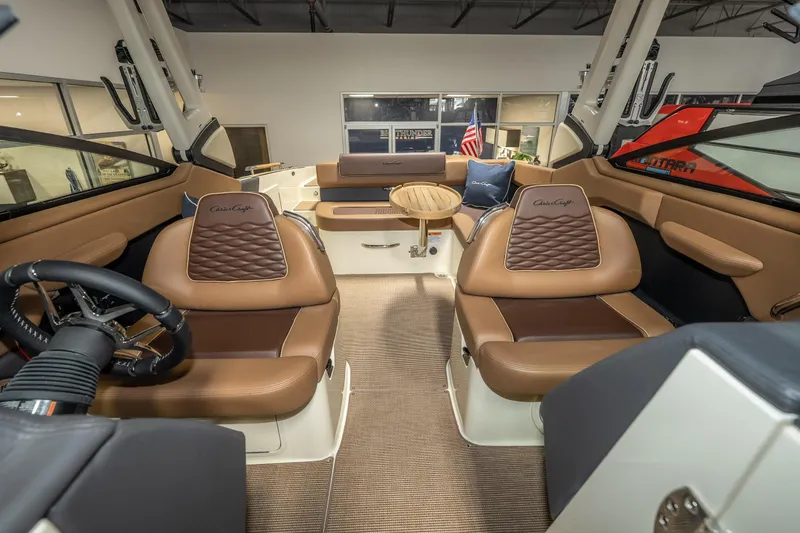 Slide: The Image of Luxurious interior of 2026 Chris-Craft Sportster 28 boat with elegant seating and steering wheel. - 30