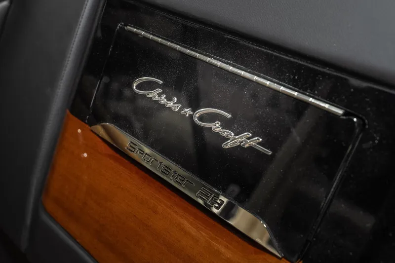 Slide: The Image of 2026 Chris-Craft Sportster 28 logo on sleek black and wood panel. - 31