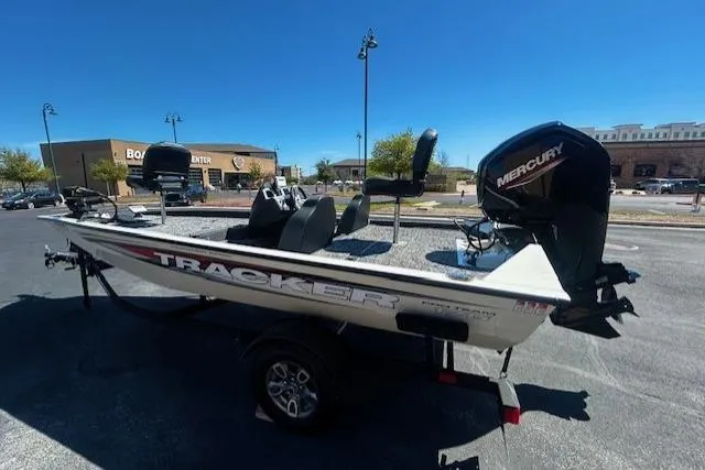 Slide: The Image of 2025 Tracker Pro Team 175 TXW boat with Mercury engine in parking lot. - 4