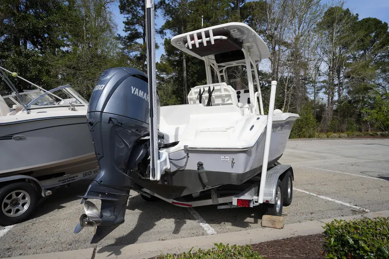 Slide: The Image of 2024 Key West 219 FS boat with Yamaha engine on trailer in parking lot. - 2