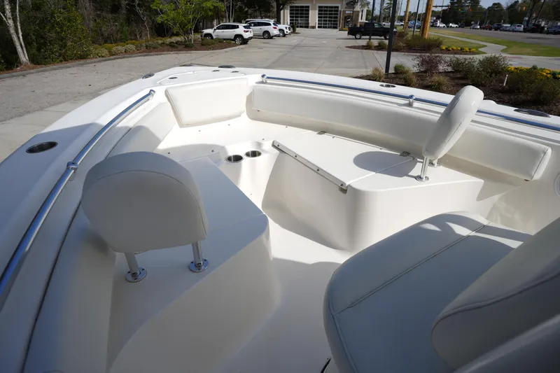 Slide: The Image of 2024 Key West 219 FS boat interior with white seating and cup holders. - 23