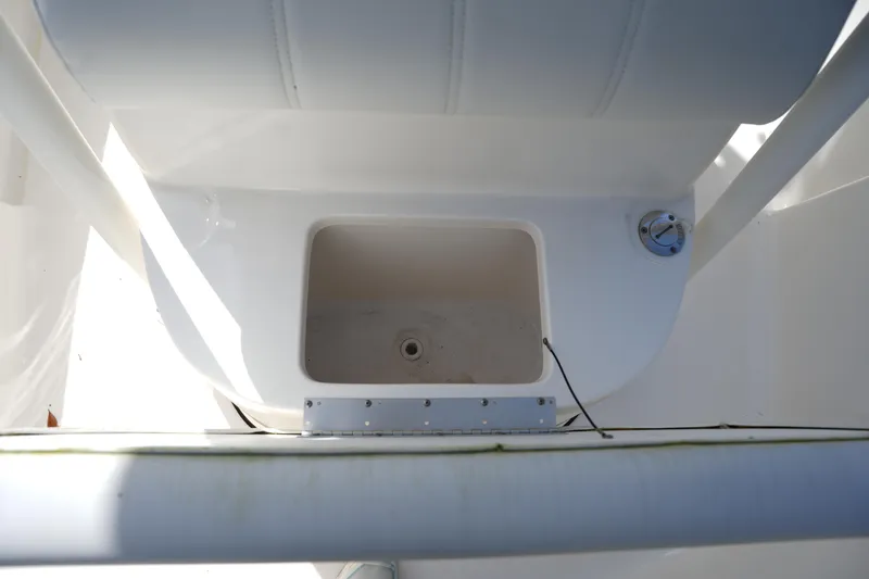 Slide: The Image of 2024 Key West 219 FS boat storage compartment with white interior. - 24