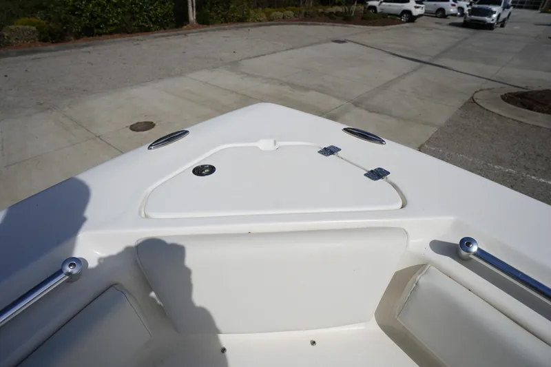 Slide: The Image of 2024 Key West 219 FS boat bow area with seating and storage compartment. - 27