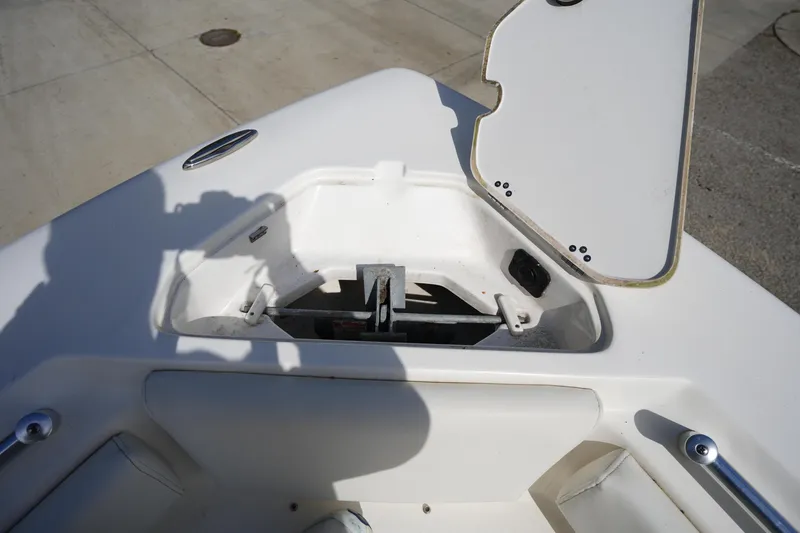 Slide: The Image of 2024 Key West 219 FS boat anchor compartment with open hatch on deck. - 28