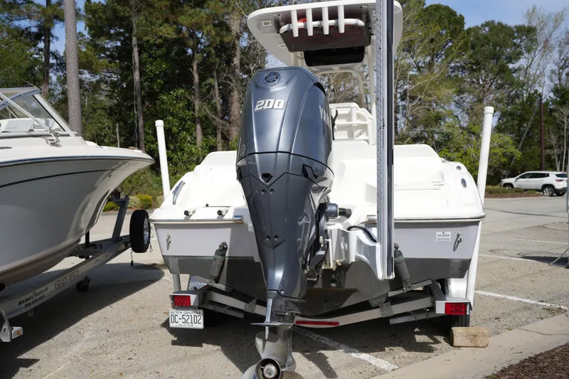 Slide: The Image of 2024 Key West 219 FS boat with Yamaha 200 outboard motor in parking lot. - 3