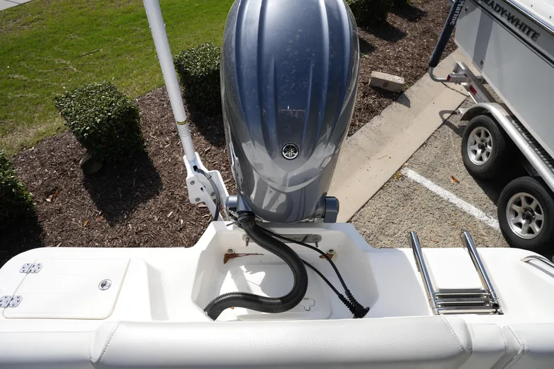 Slide: The Image of 2024 Key West 219 FS boat with outboard motor and trailer in parking area. - 4