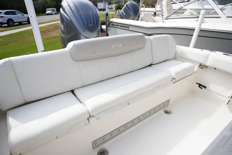 Slide: The Image of 2024 Key West 219 FS boat interior with white seating and Yamaha engine. - 5