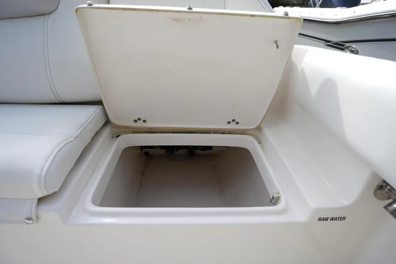 Slide: The Image of Open storage compartment on 2024 Key West 219 FS boat, labeled "Raw Water." - 6