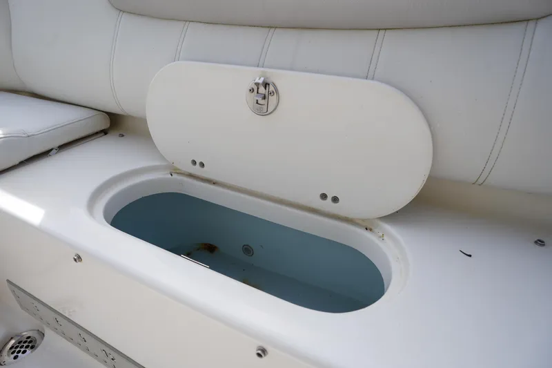 Slide: The Image of Livewell compartment on 2024 Key West 219 FS boat, featuring white cushioned seating. - 7