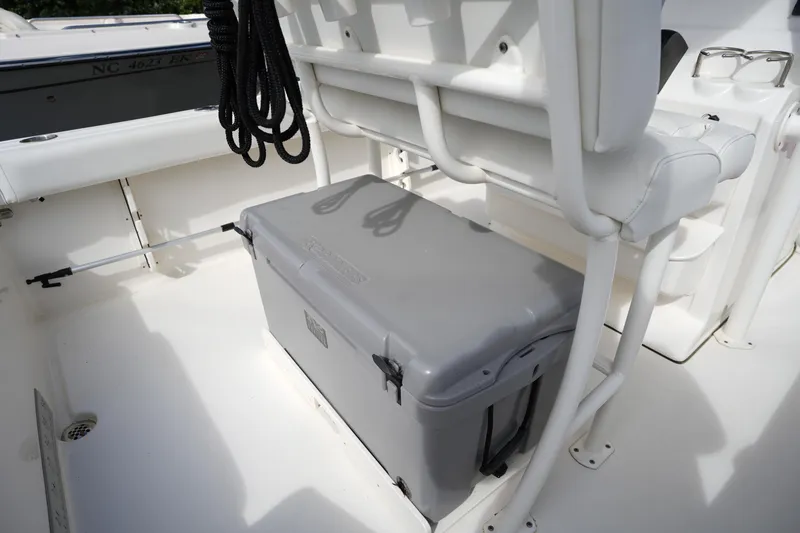 Slide: The Image of 2024 Key West 219 FS boat interior with cooler and seating arrangement. - 8