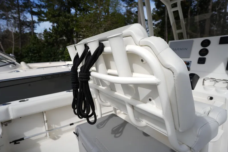 Slide: The Image of 2024 Key West 219 FS boat interior with white seating and black rope detail. - 9
