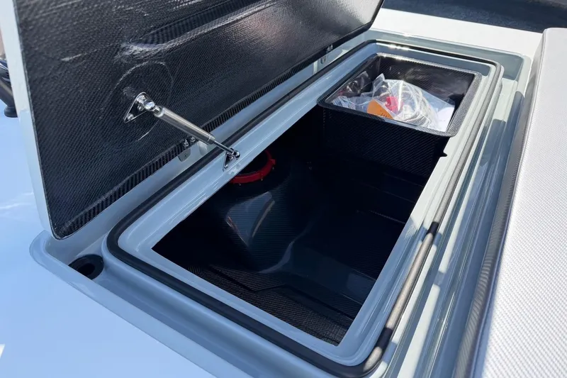 Slide: The Image of Open storage compartment of 2026 Chittum Skiffs 18 Laguna Madre boat. - 14