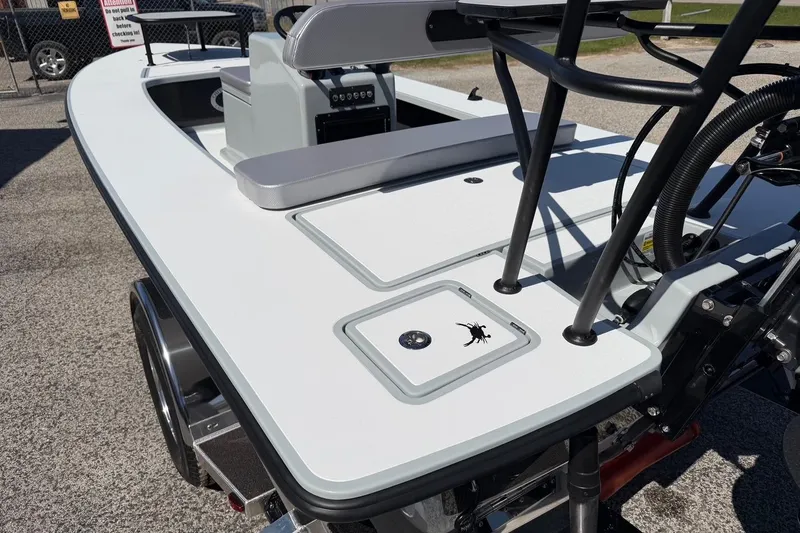 Slide: The Image of 2026 Chittum Skiffs 18 Laguna Madre boat, sleek design, white deck, outdoor setting. - 16