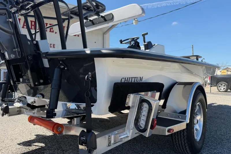 Slide: The Image of 2026 Chittum Skiffs 18 Laguna Madre boat on trailer, rear view, sunny day. - 17