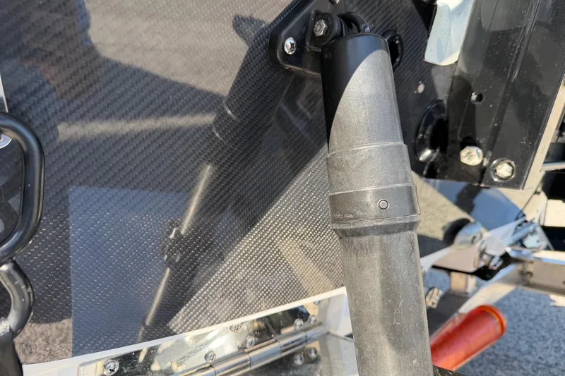 Slide: The Image of Close-up of 2026 Chittum Skiffs 18 Laguna Madre boat detail, featuring carbon fiber texture. - 18